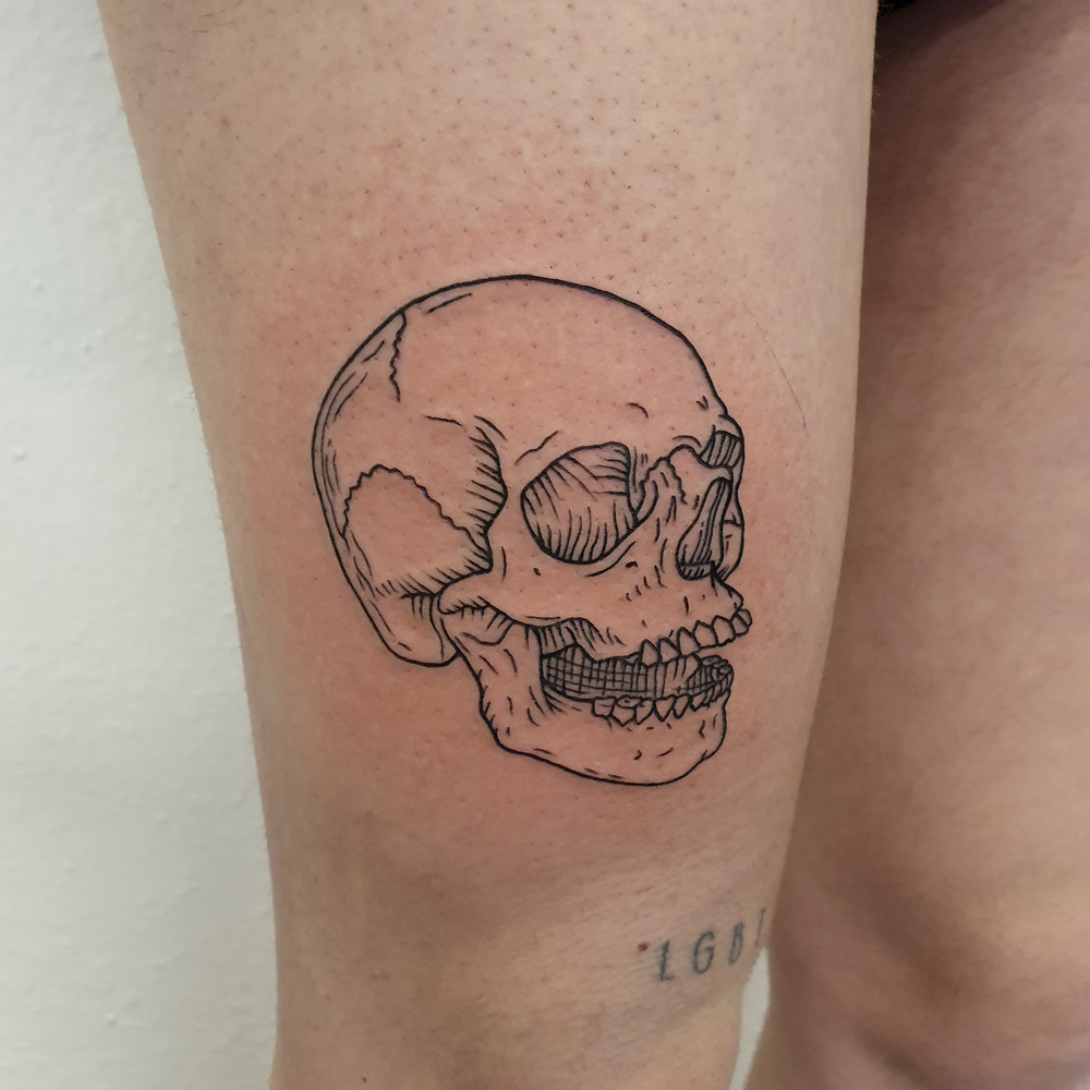 Etching tattoo of a human skull.