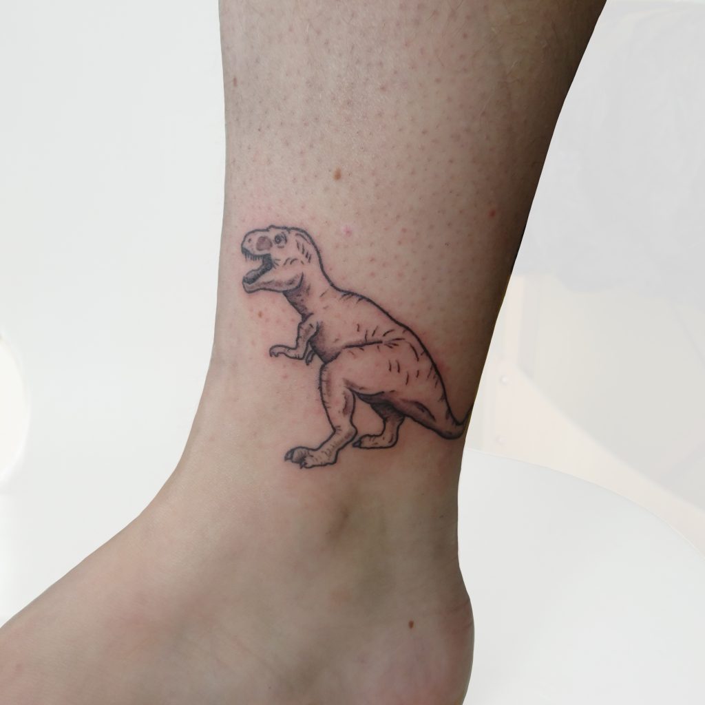 Small T-Rex tattoo in black