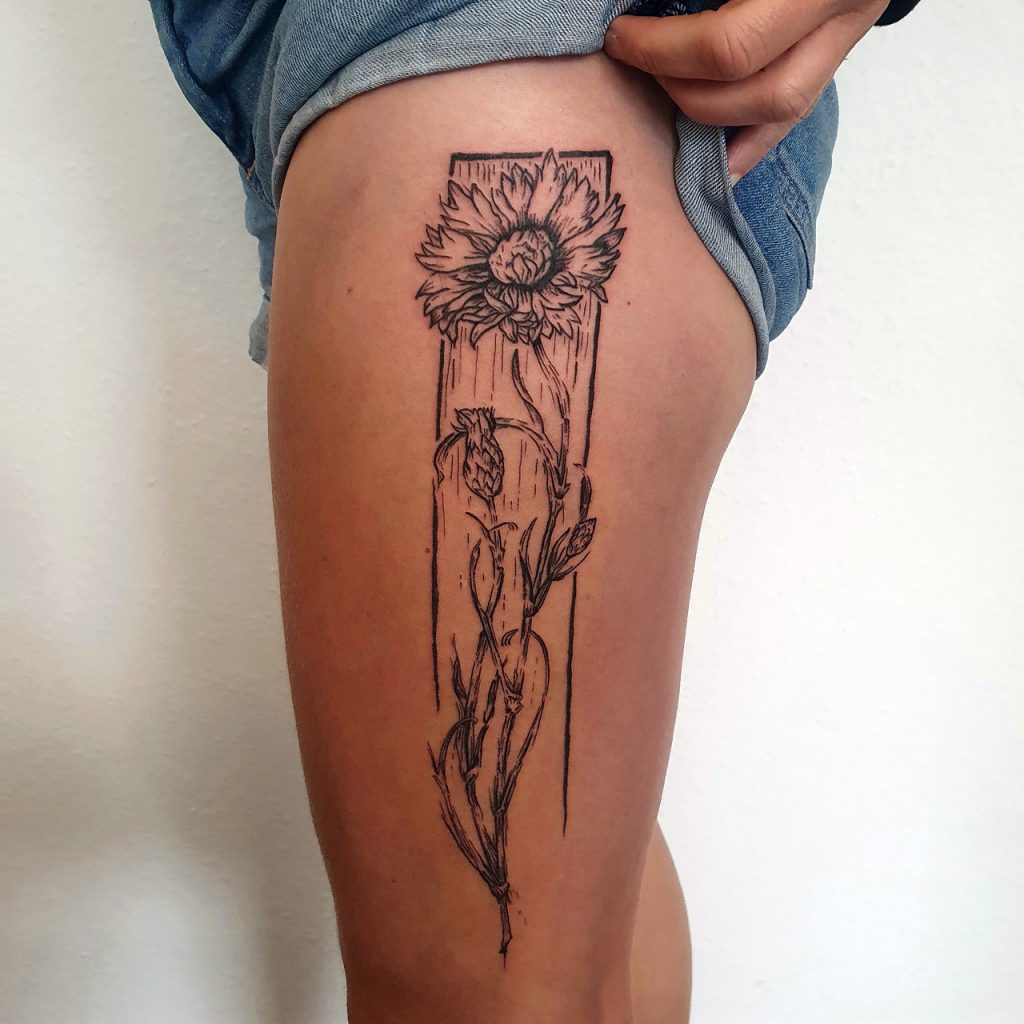 large corn flower tattoo on leg, lineworktattoo style
