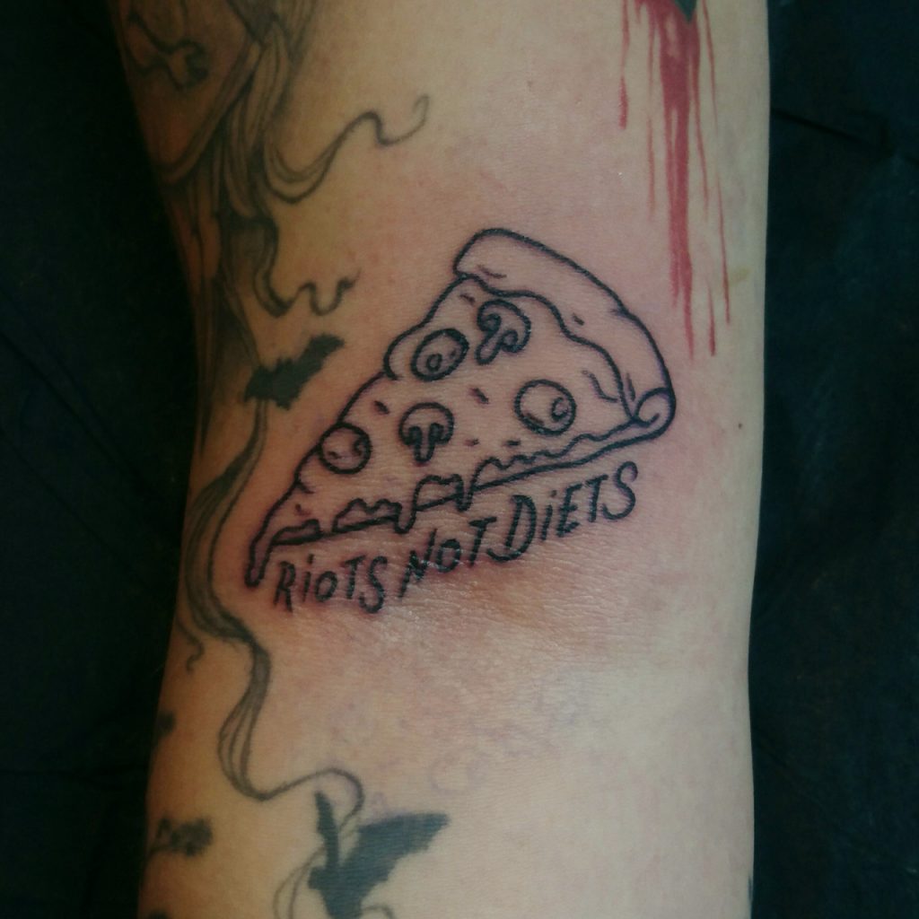 small ignorant style pizza tattoo with "riots not diets" text