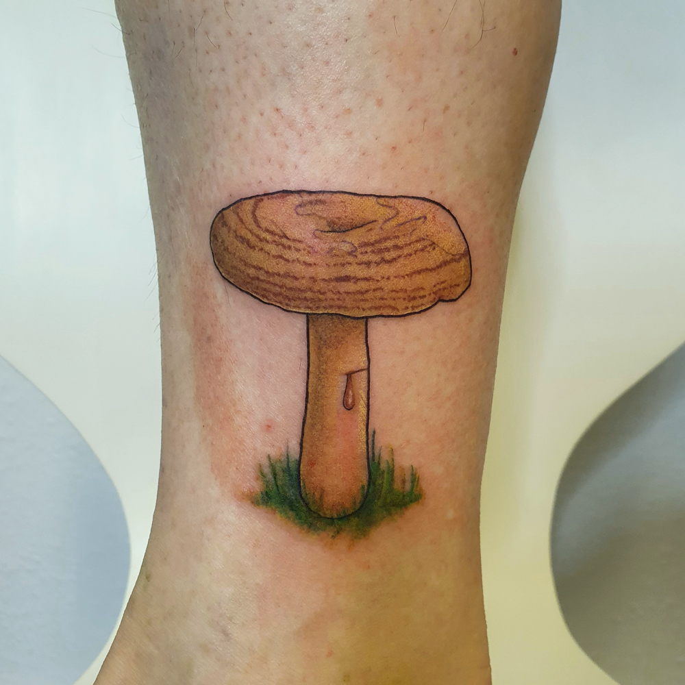 Colorful orange milcap mushroom tattoo